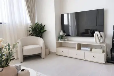 a living room with a large mirror and a chair at Luxury 1BR Haven W Private Pool - Binghatti Royale in Dubai