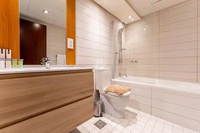 a bathroom with a toilet and a tub and a sink at HAVN - 1 Bedroom in Downtown Dubai in Dubai