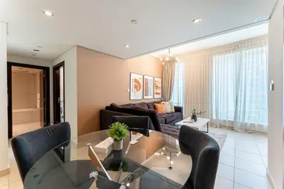 a living room with a glass table and a couch at HAVN - 1 Bedroom in Downtown Dubai in Dubai