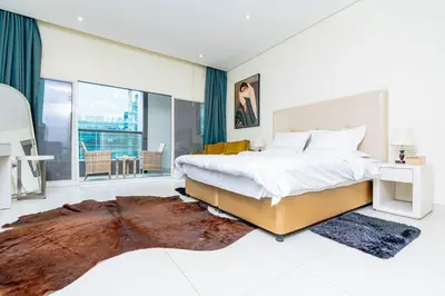 a bedroom with a large bed and a large window at Nasma Luxury stays - Executive stay with hotel facilities in Dubai