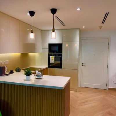 a kitchen with a white counter top and a refrigerator at Elegant apartment in a prime location in Dubai