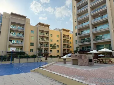 an apartment complex with a basketball court in a courtyard at Elegant apartment in a prime location in Dubai