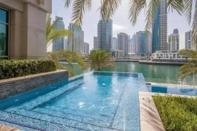 a swimming pool with a view of the city at Bright, modern flat on the Marina Promenade in Dubai