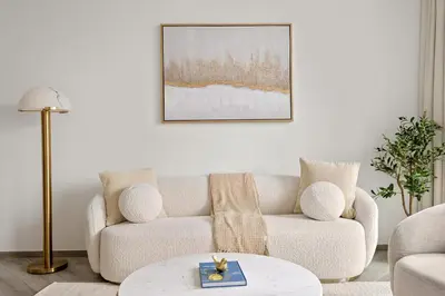a living room with a couch and a table at VayK - Luxury 1 BD with Panoramic Canal Views in Dubai