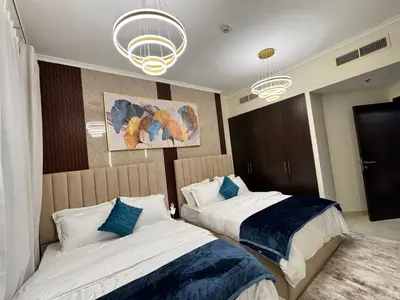 a bedroom with two beds and two chandeliers at Spacious 2BR Apartment-Marina Walk Luxury Stay-Enjoy Dubai Marina Views in Dubai