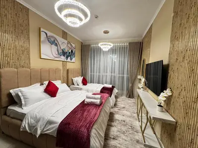 a bedroom with a large bed with red pillows at Spacious 2BR Apartment-Marina Walk Luxury Stay-Enjoy Dubai Marina Views in Dubai