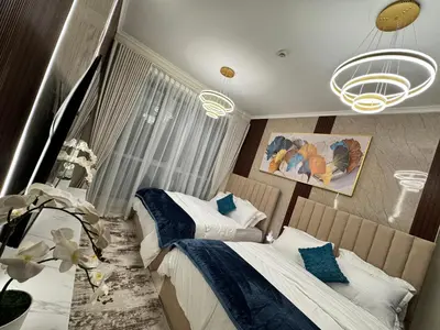 a bedroom with two beds and a chandelier at Spacious 2BR Apartment-Marina Walk Luxury Stay-Enjoy Dubai Marina Views in Dubai