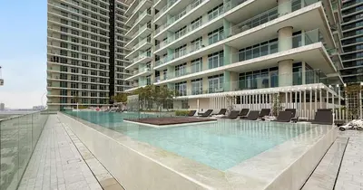 a swimming pool in the middle of a building at Luxury 3BHK & Maid Sea View & Private Beach in Sabkhah