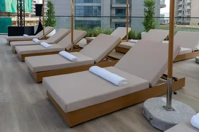 a row of chaise lounges in a building at Serene 1BR Retreat W Private Pool Binghatti Royale in Dubai
