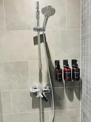 a shower in a bathroom with a shower head at Superb 1BR high floor apartment on Sobha Hartland in Dubai