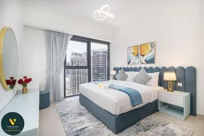 a bedroom with a large bed and a large window at Vogue Downtown Act One near Burj Khalifa and Dubai Mall, Two Bedroom Apartment with Balcony and City Skyline View, Access to all Amenities in Dubai