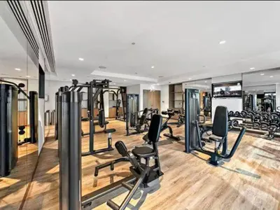 a gym with a lot of treadmills and machines at Vogue Downtown Act One near Burj Khalifa and Dubai Mall, Two Bedroom Apartment with Balcony and City Skyline View, Access to all Amenities in Dubai