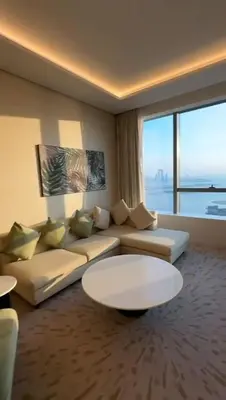 a living room with a couch and a table at PALM TOWER by Design Studio 1 BR in Dubai