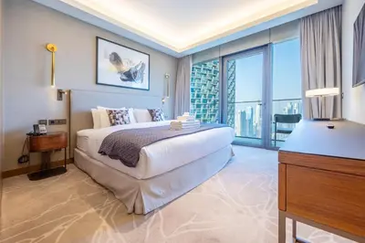 a bedroom with a large bed and a large window at 3br on the 49th floor of Address Opera in Dubai