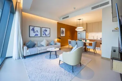 a living room with a couch and a table at 3br on the 49th floor of Address Opera in Dubai