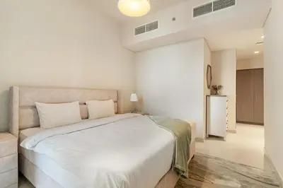 a bedroom with a large white bed in a room at Premium 2BR with Park View in Dubai Creek Harbour in Dubai
