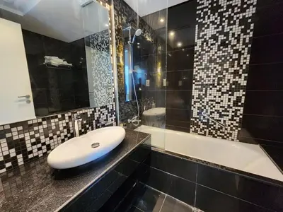 a bathroom with a sink and a bath tub at Golden Grove 1 Bhk Bays Edge 1 Business bay in Dubai