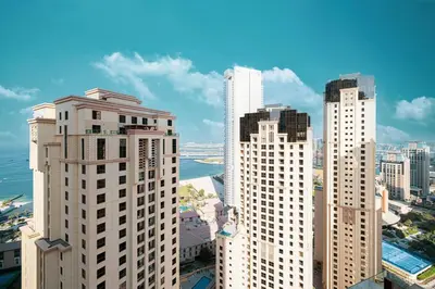 a group of tall buildings in a city at Stunning 2BR with Sea View Murjan 1 Near Beach in Dubai