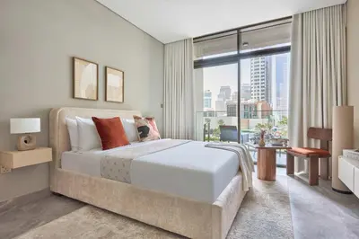 a bedroom with a large bed and a large window at Frank Porter - Peninsula One in Dubai