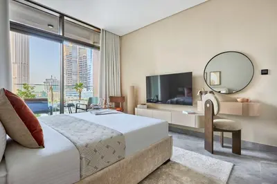 a bedroom with a large bed and a large mirror at Frank Porter - Peninsula One in Dubai