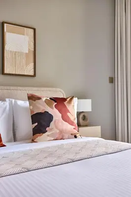 a bedroom with a bed with a white sheets and pillows at Frank Porter - Peninsula One in Dubai