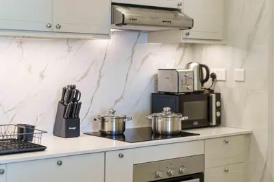 a kitchen with two pots and a microwave at Modern Upgraded 1BR - High Floor with Ocean View in Dubai