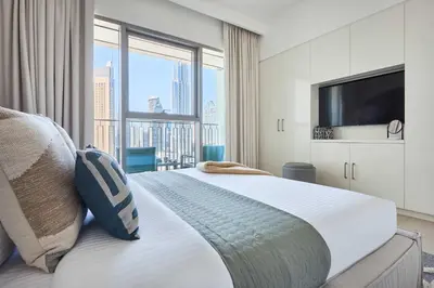a bedroom with a large bed with a large window at Frank Porter - Downtown Views II in Dubai
