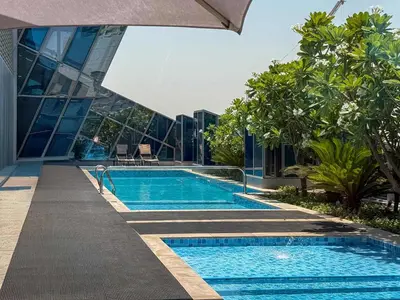 a swimming pool in front of a building at Frank Porter - J One Tower, Business Bay in Dubai