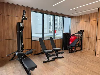 a gym with chairs and equipment in a room at Elegant Retreat Studio in Azizi Mirage in Dubai