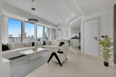 a white living room with a couch and a table at Stunning 2 Bedroom Apartment in Dubai Marina in Dubai