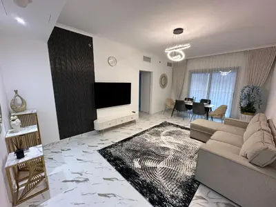 a living room with a couch and a flat screen tv at Premium 2BR Marina View Apartment in Dubai Marina in Dubai