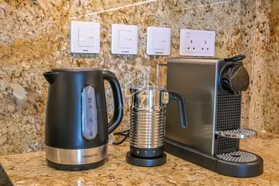 a coffee maker and a blender on a counter at Luxury Urban Living at Imperial Avenue, Downtown in Dubai