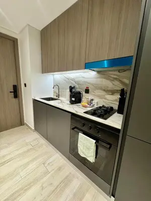 a kitchen with a stove and a counter top at Restay Homes at Oxford Gardens - Great City Escape - Swimming Pool Access in Dubai