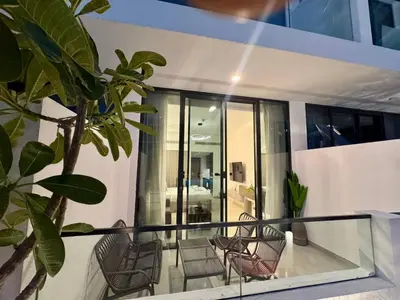 a balcony of a house with chairs at Restay Homes at Oxford Gardens - Great City Escape - Swimming Pool Access in Dubai
