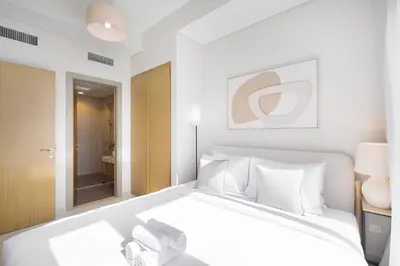 a bedroom with a large white bed with white pillows at StayShort - Elegant 2 BR in Business Bay with Amazing Views that sleeps 5 in Dubai
