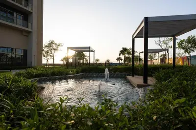 a fountain in a pond in front of a building at StayShort - Elegant 2 BR in Business Bay with Amazing Views that sleeps 5 in Dubai