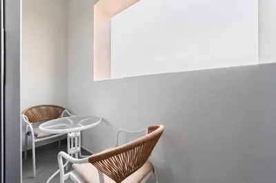 a room with two chairs and a table and a mirror at Elegant 1BR Apartment in Ikarus, Dubai Production City in Dubai