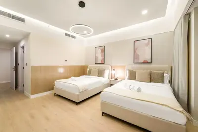 two beds in a room with two beds sidx sidx sidx sidx sidx at FIRST CLASS 2BR Sea, Palm & Atlantis Views in Dubai