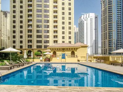 a large swimming pool in a city with tall buildings at FIRST CLASS 2BR Sea, Palm & Atlantis Views in Dubai