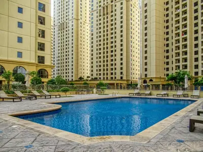 a swimming pool in the middle of some tall buildings at FIRST CLASS 2BR Sea, Palm & Atlantis Views in Dubai