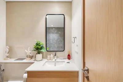 a bathroom with a sink and a mirror at Luxury 2BR with Burj Khalifa View in Port Rashid in Dubai