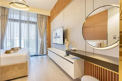 a hotel room with a bed and a mirror at Modern Luxe Studio in the Heart of Meydan in Dubai