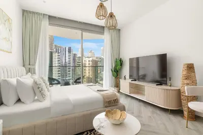 a bedroom with a large bed and a large window at Chic Studio in Peninsula Three, Business Bay in Dubai