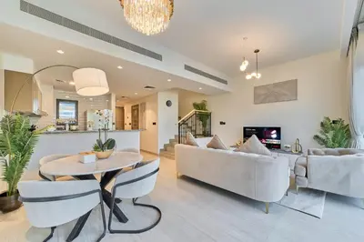 a living room with a couch and a table at Premium 3 Bedroom Townhouse in DAMAC Lagoons in Dubai