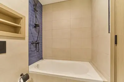 a bathroom with a white tub and a shower at Premium 3 Bedroom Townhouse in DAMAC Lagoons in Dubai