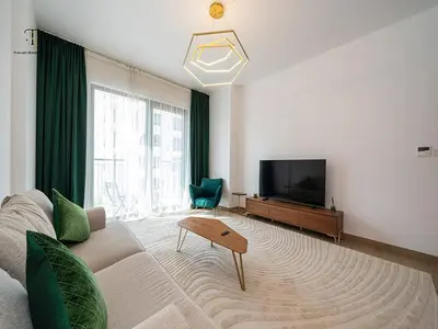 a living room with a couch and a flat screen tv at Luxury Loft 1 Bedroom La Voile - Building 1 Jumeirah 1 in Dubai