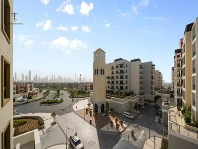 a building with a clock tower in the middle of a city at Luxury Loft 1 Bedroom La Voile - Building 1 Jumeirah 1 in Dubai