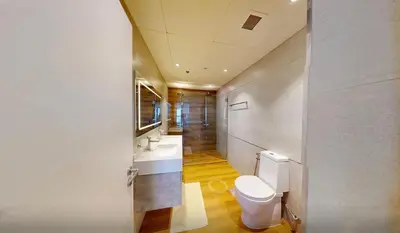 a bathroom with a white toilet and two sinks at Modern 2-Bedroom Apartment with JBR and Marina view on High floor in Dubai