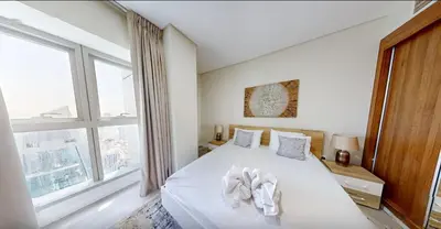 a bedroom with a white bed with a large window at Modern 2-Bedroom Apartment with JBR and Marina view on High floor in Dubai