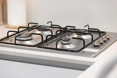 a stove top oven with four burners on it at Restay Homes at Luma22 West Tower in Dubai